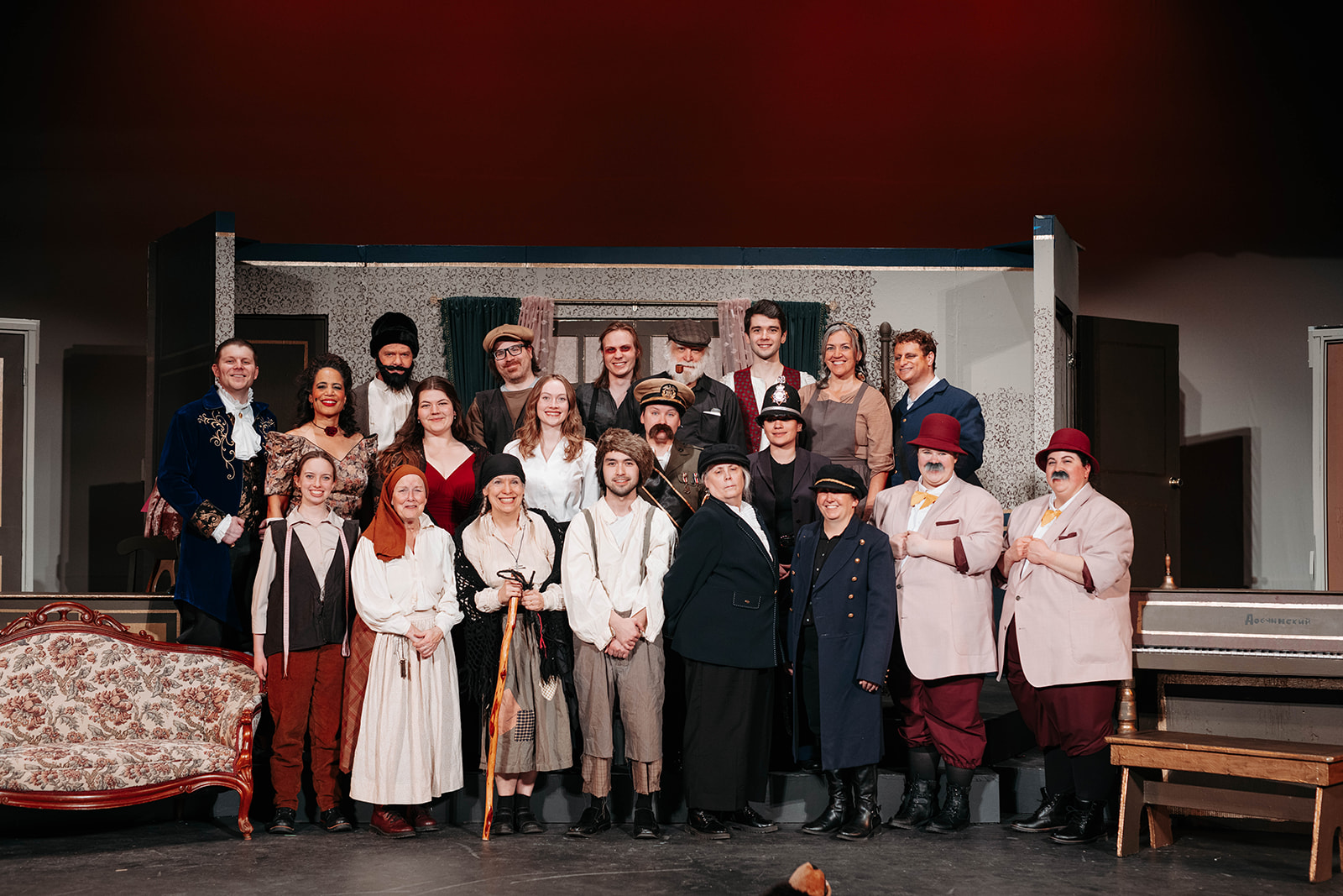 Rosetown Playhouse Full cast photo showing all performers in their various period costumes posed together on the multi-level stage set, with ornate furniture visible.